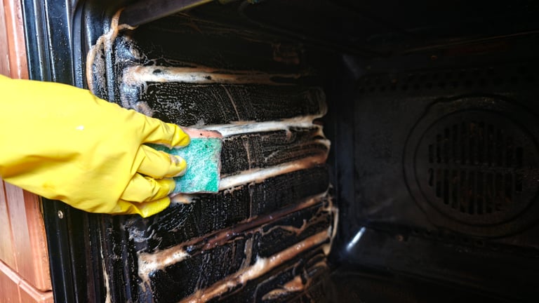 Professional cleaner deep cleaning the inside of an oven